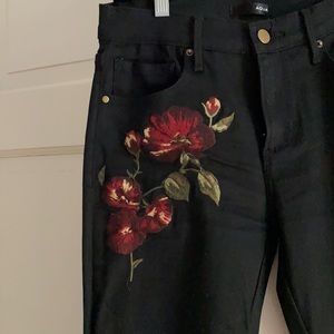 Aqua black jeans with floral embroidery.